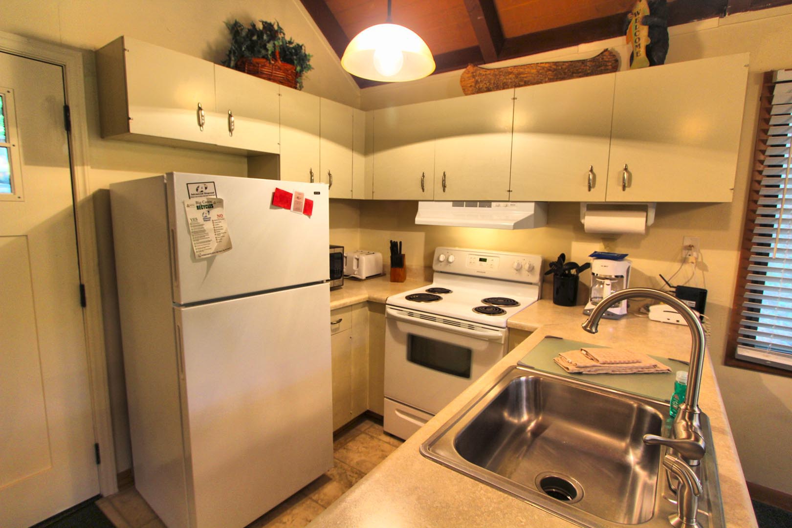 a fully equipped kitchen at VRI's Golf Club Villas in Marble Hill, Georgia.